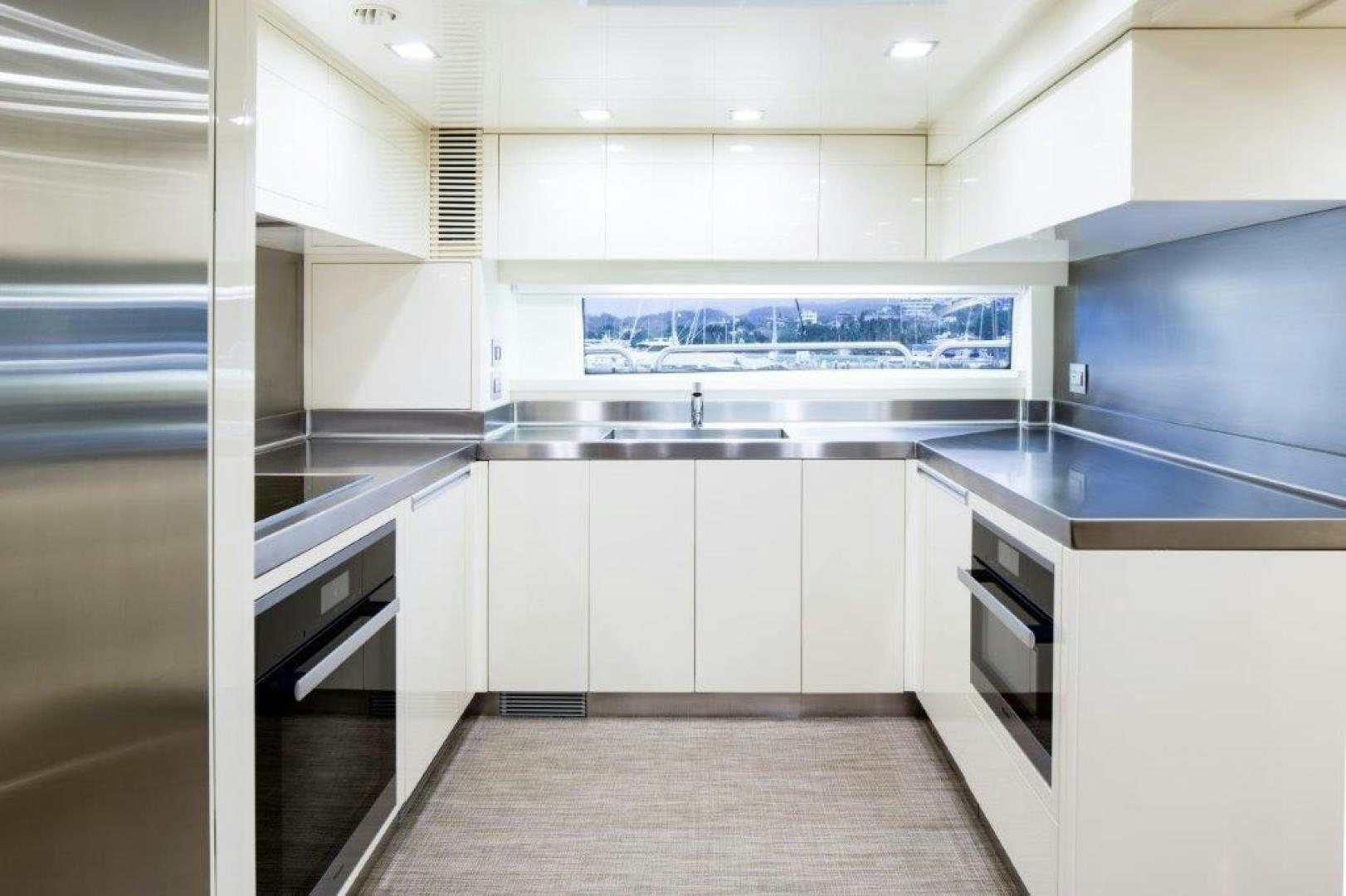 a kitchen with white cabinets aboard AMANECER Yacht for Sale