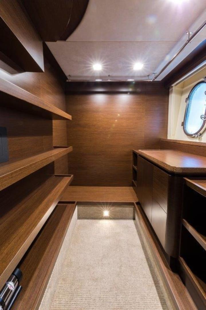 a wooden staircase with a wood railing aboard AMANECER Yacht for Sale