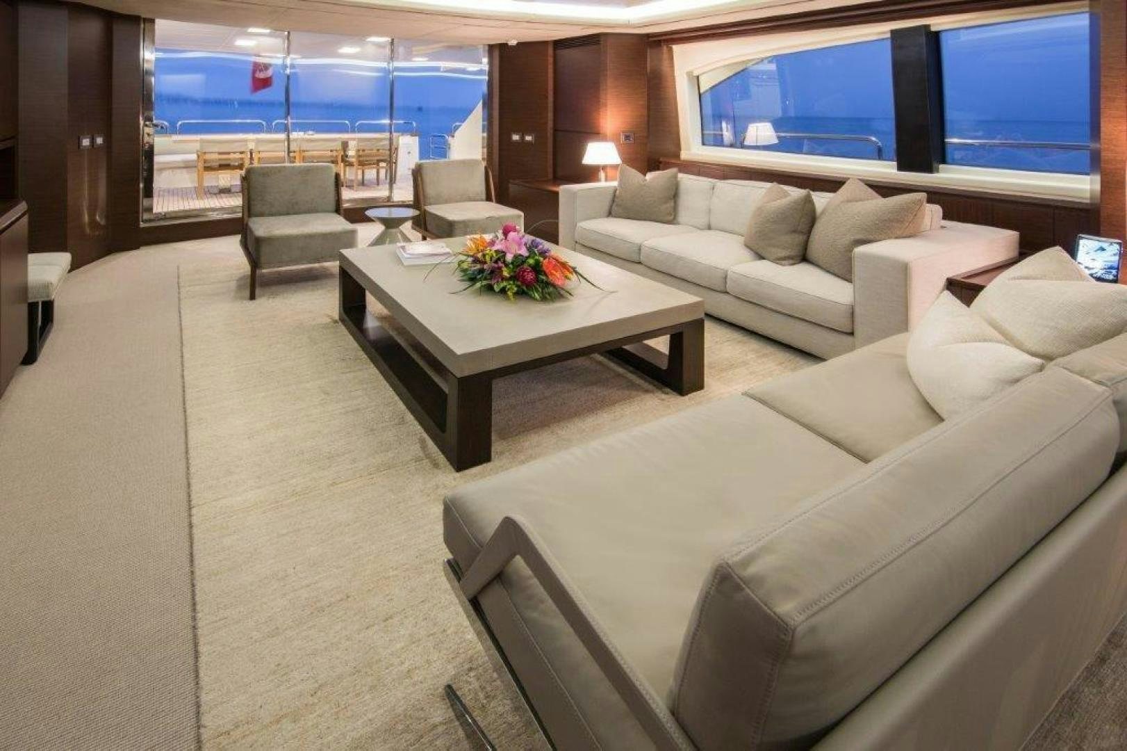 a living room with a large sofa aboard AMANECER Yacht for Sale