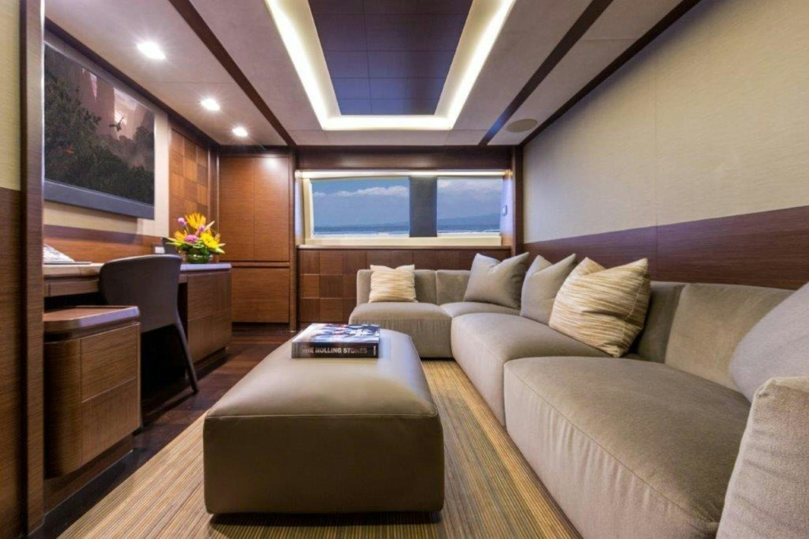 a living room with a couch and a tv aboard AMANECER Yacht for Sale