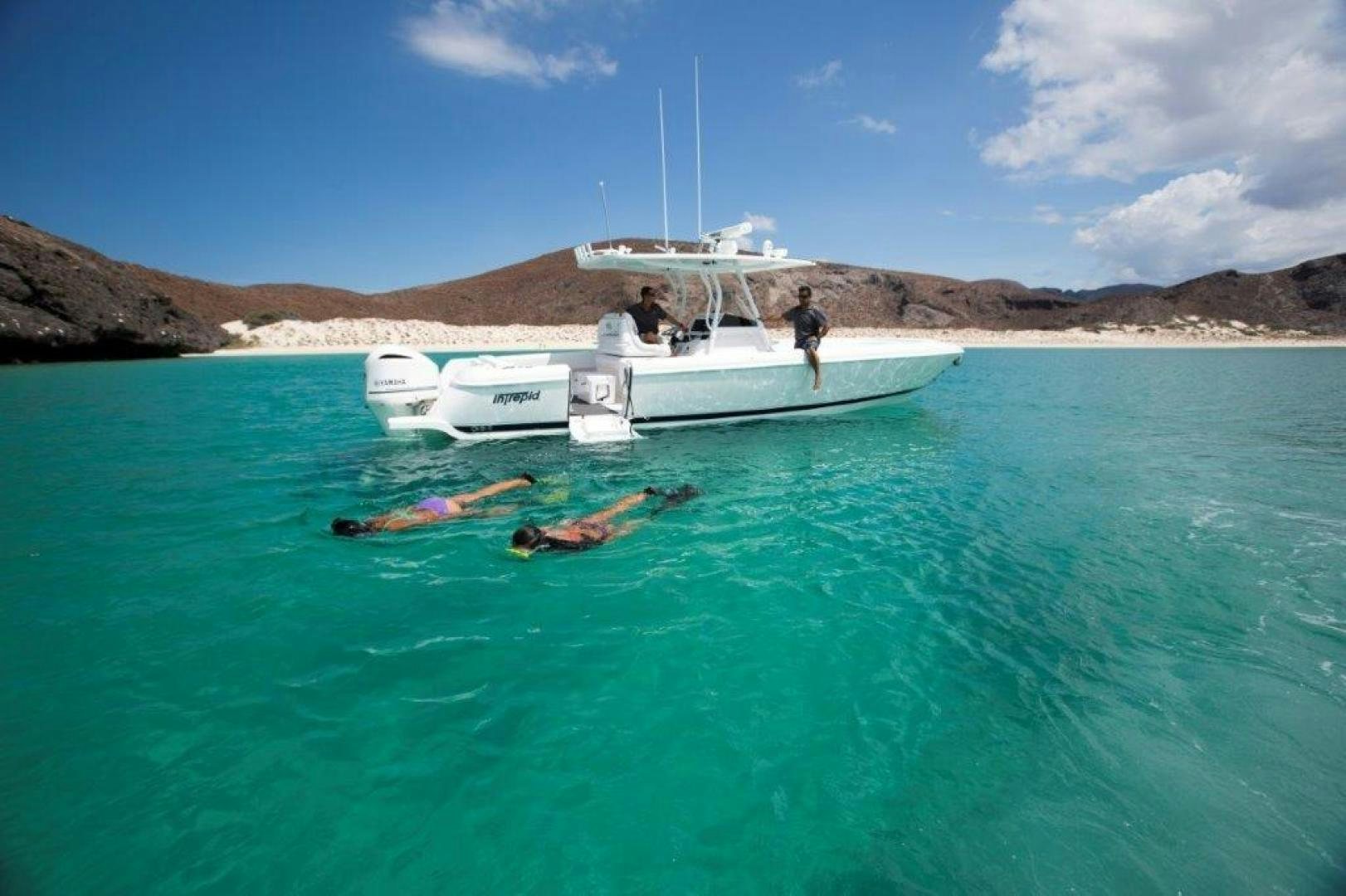 a person standing on a boat in the water aboard AMANECER Yacht for Sale
