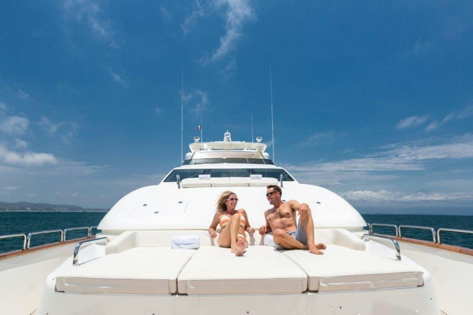 a group of people sitting on a boat aboard AMANECER Yacht for Sale