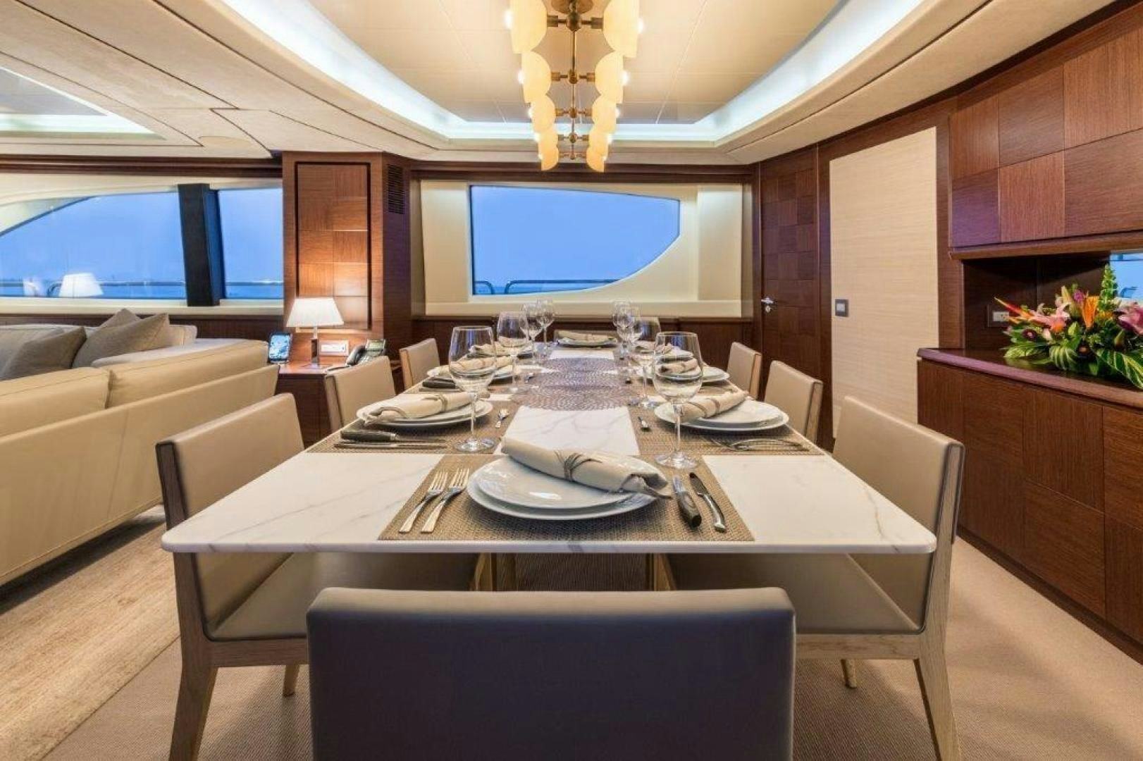 a dining table set for a dinner aboard AMANECER Yacht for Sale