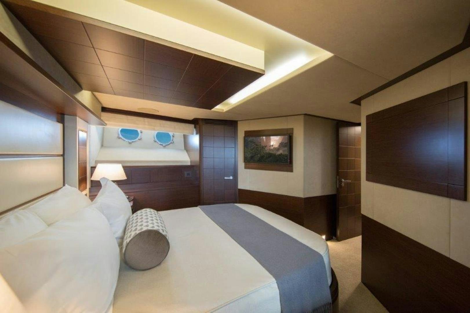 a room with a bed and a television aboard AMANECER Yacht for Sale