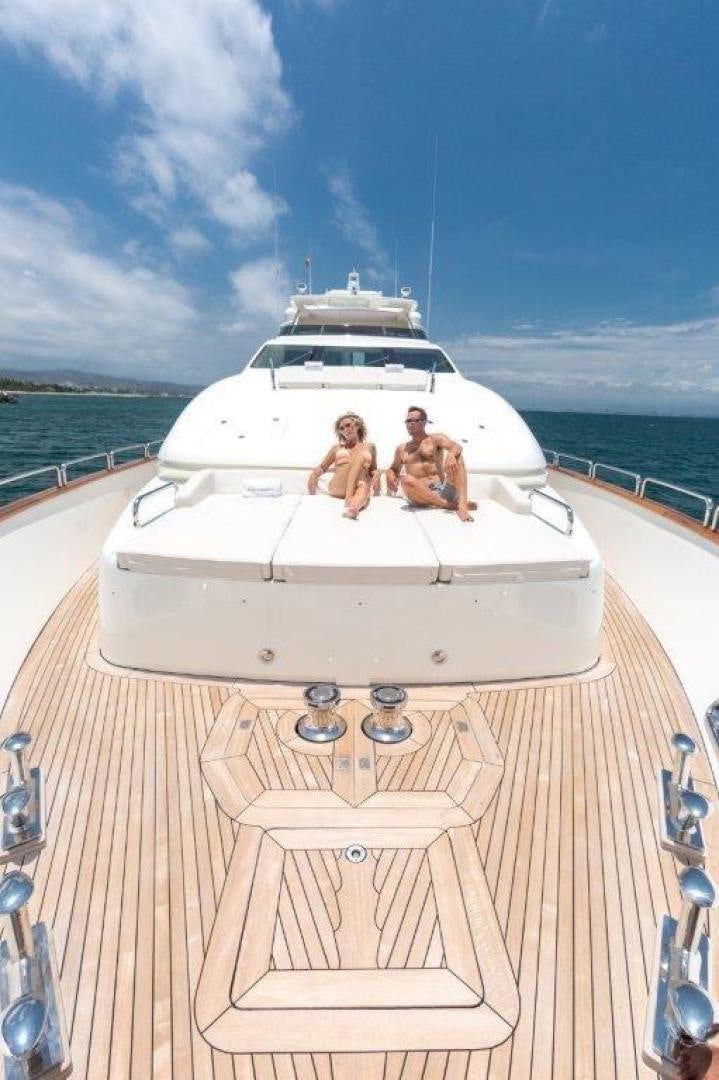 a couple of people sitting on a boat on a body of water aboard AMANECER Yacht for Sale