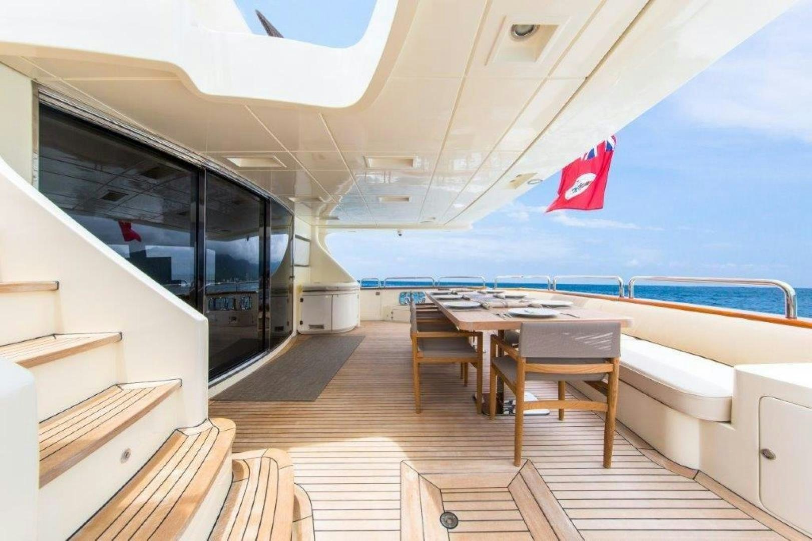 a boat with a table and chairs aboard AMANECER Yacht for Sale