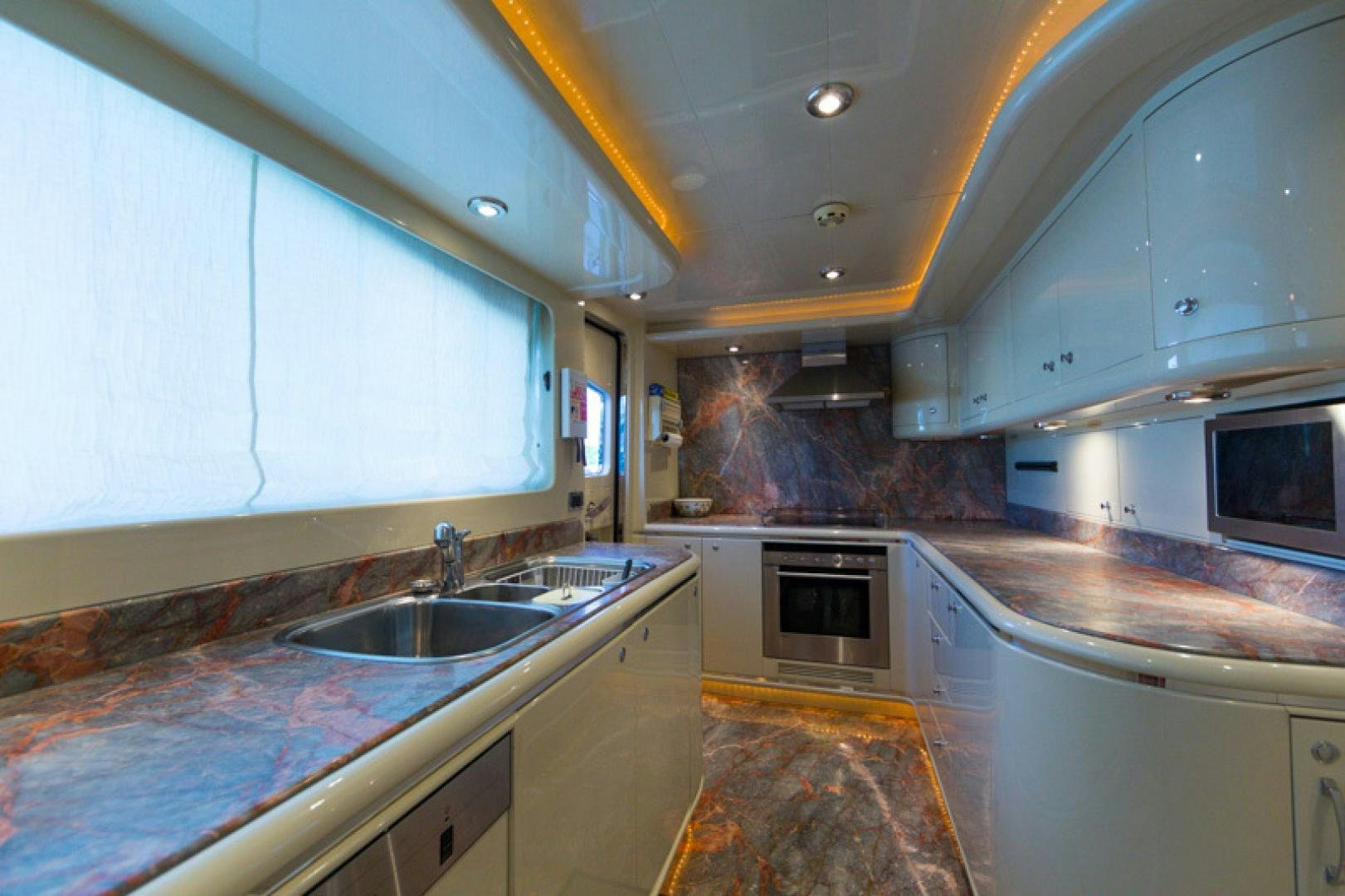 a kitchen with a sink and microwave aboard MR. CAT Yacht for Sale