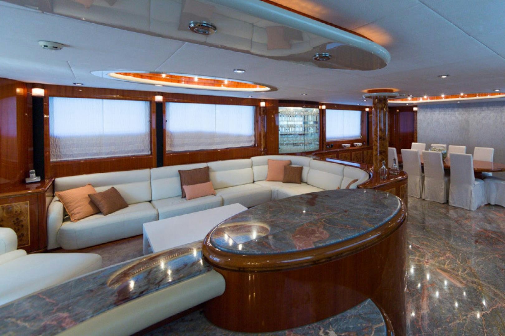 a living room with a table and couches aboard MR. CAT Yacht for Sale