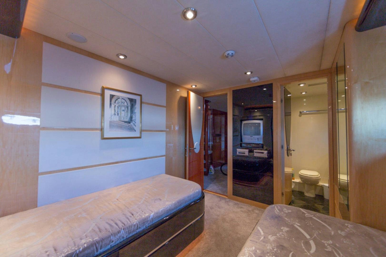 a bedroom with a bed and a television aboard MR. CAT Yacht for Sale