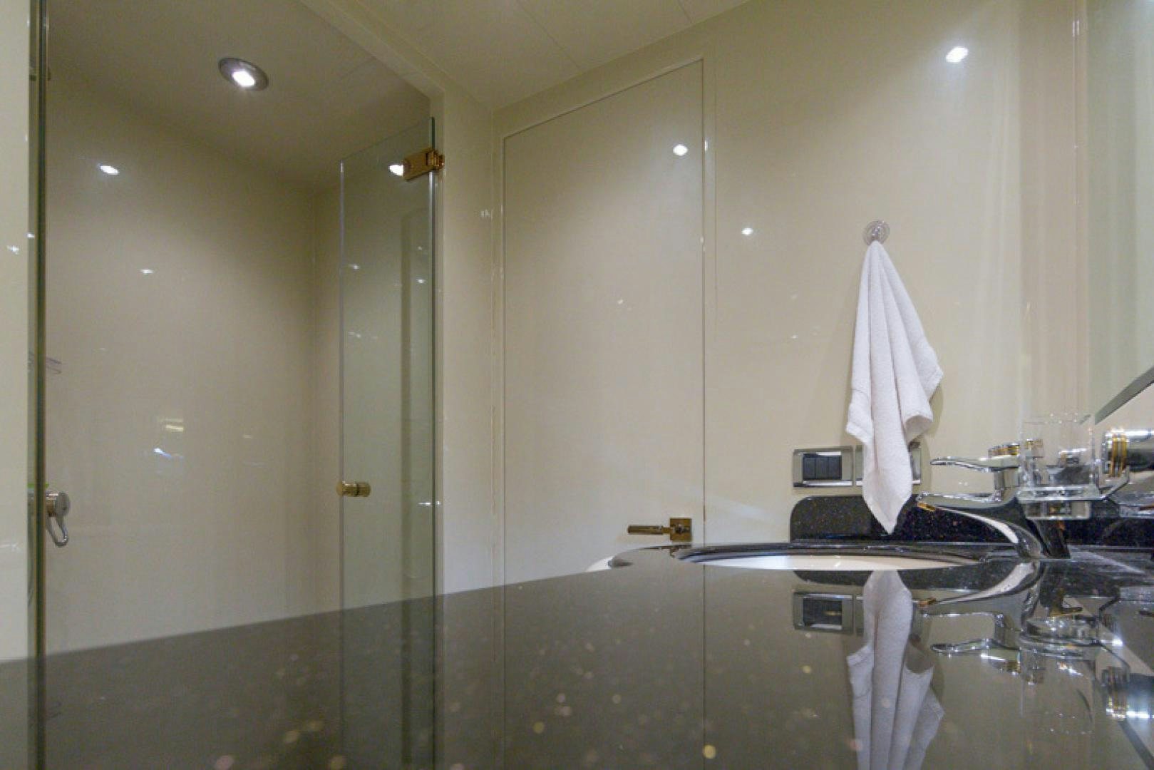 a bathroom with a glass shower aboard MR. CAT Yacht for Sale