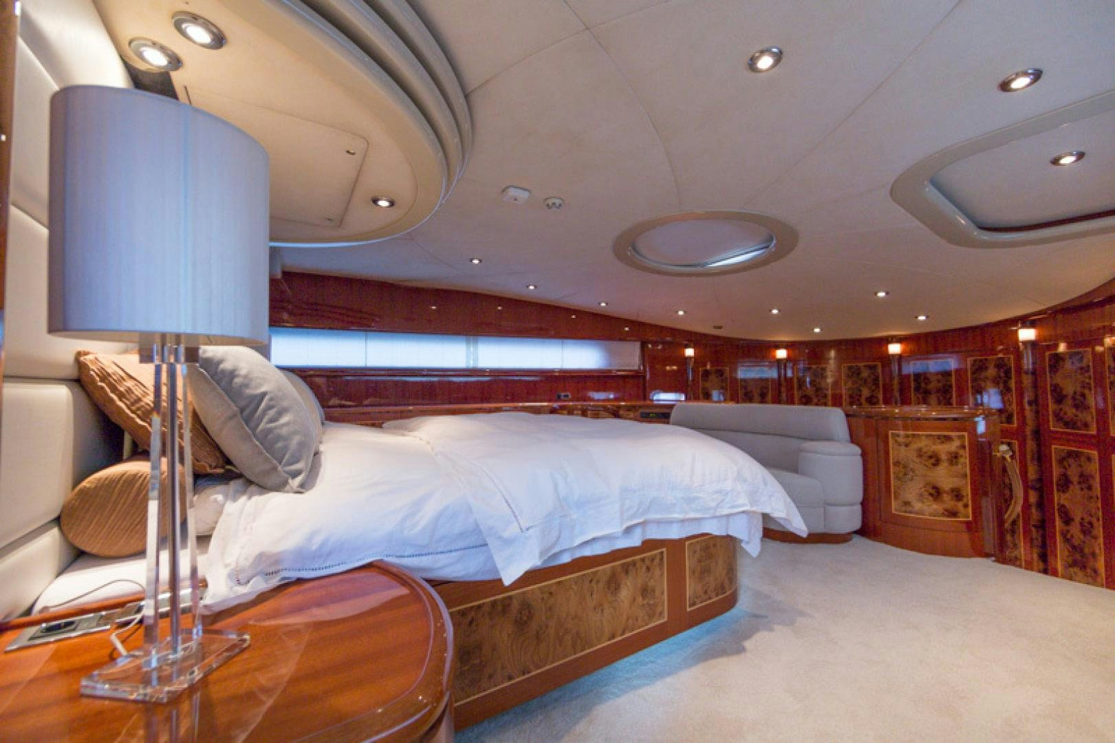 a room with a bed and a lamp aboard MR. CAT Yacht for Sale
