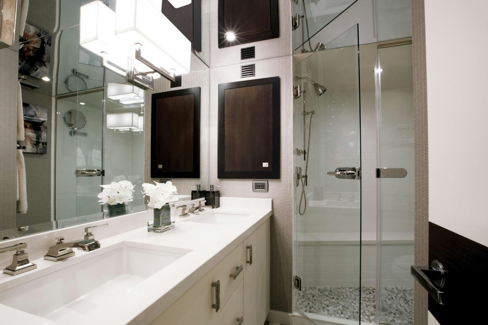 a bathroom with a glass shower aboard 2021 HATTERAS 105RPH Yacht for Sale