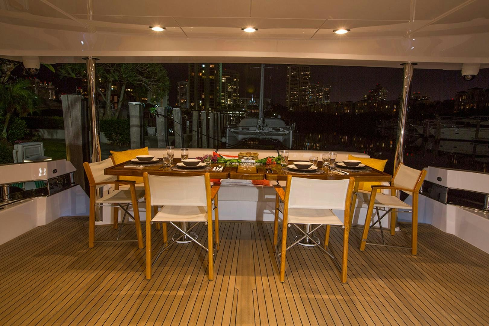 a large room with tables and chairs aboard 2021 HATTERAS 105RPH Yacht for Sale