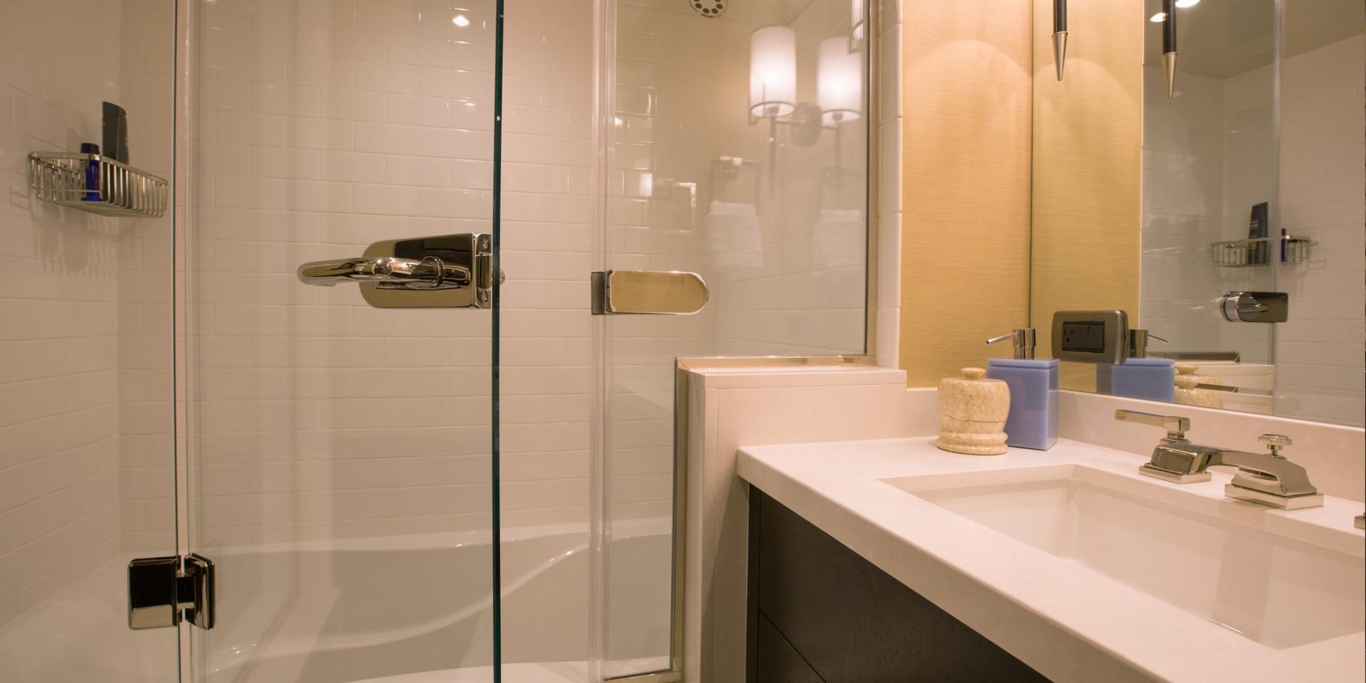a bathroom with a glass shower aboard 2021 HATTERAS 105RPH Yacht for Sale