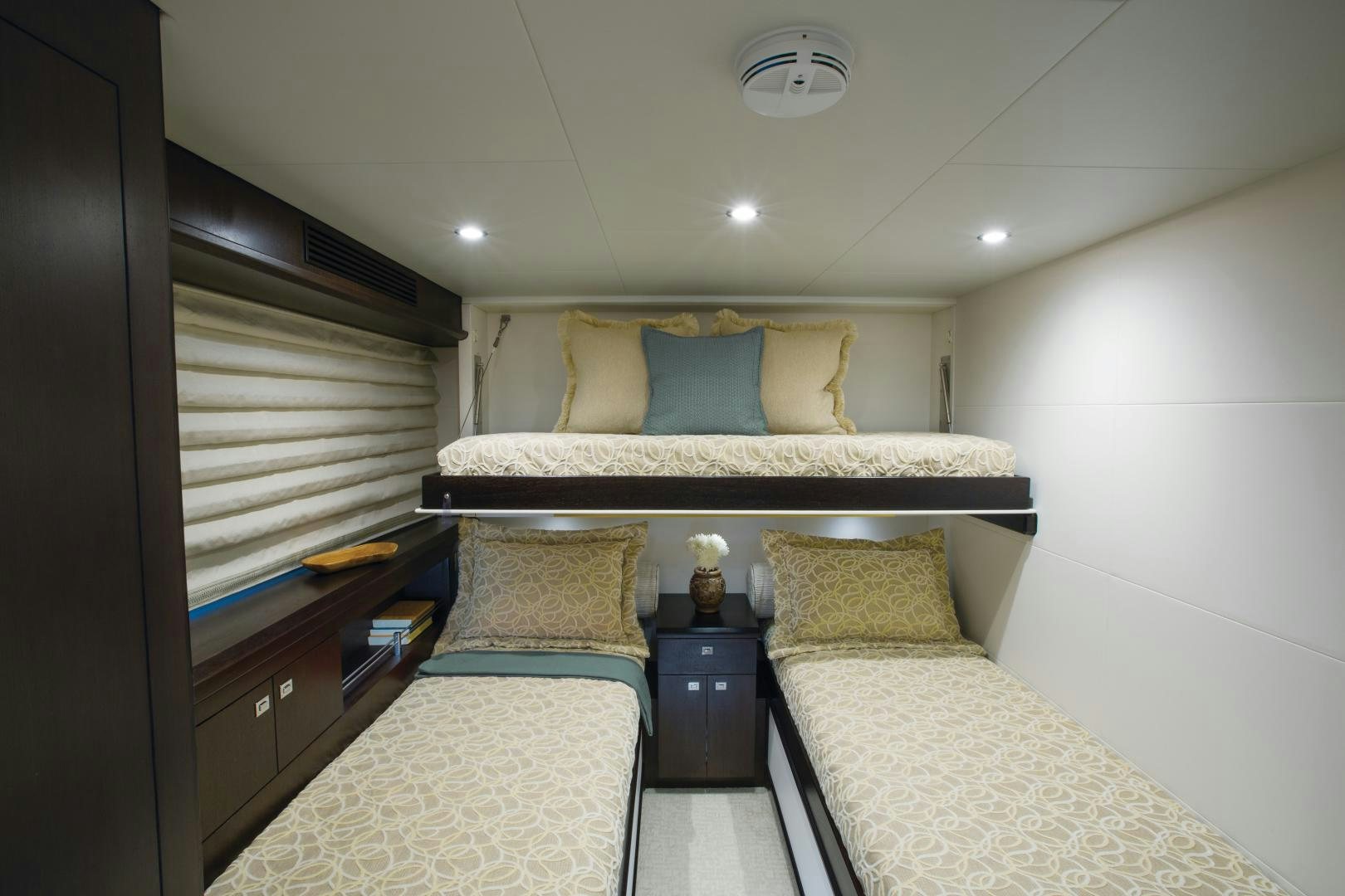 a bedroom with a bed and a dresser aboard 2021 HATTERAS 105RPH Yacht for Sale