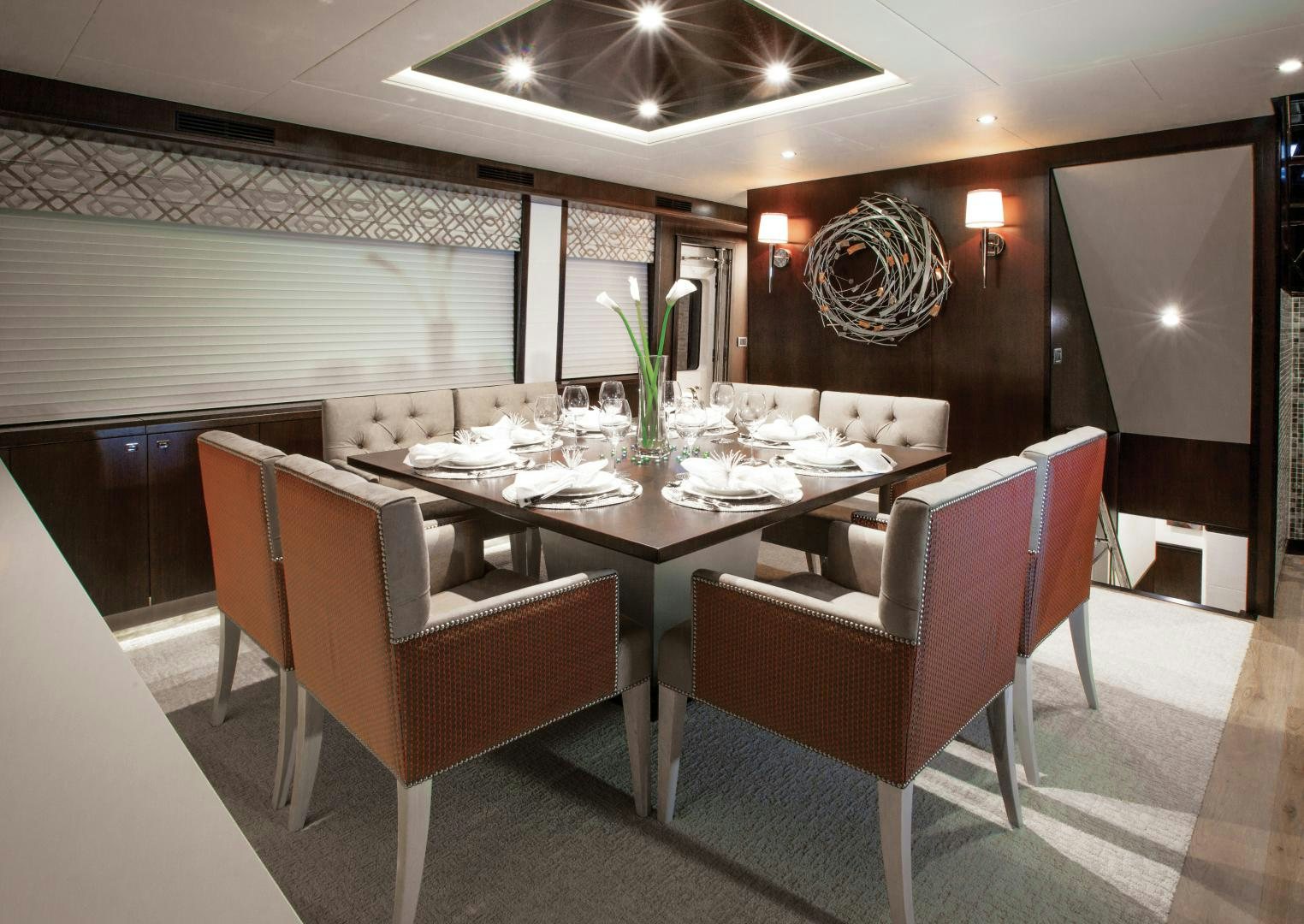 a dining room with a table and chairs aboard 2021 HATTERAS 105RPH Yacht for Sale