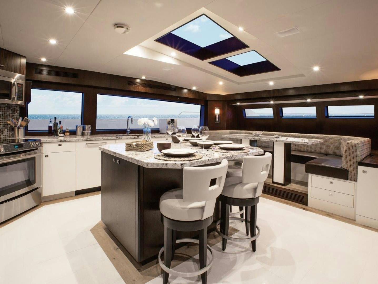 a large kitchen with a large island aboard 105 RAISED PILOTHOUSE Yacht for Sale