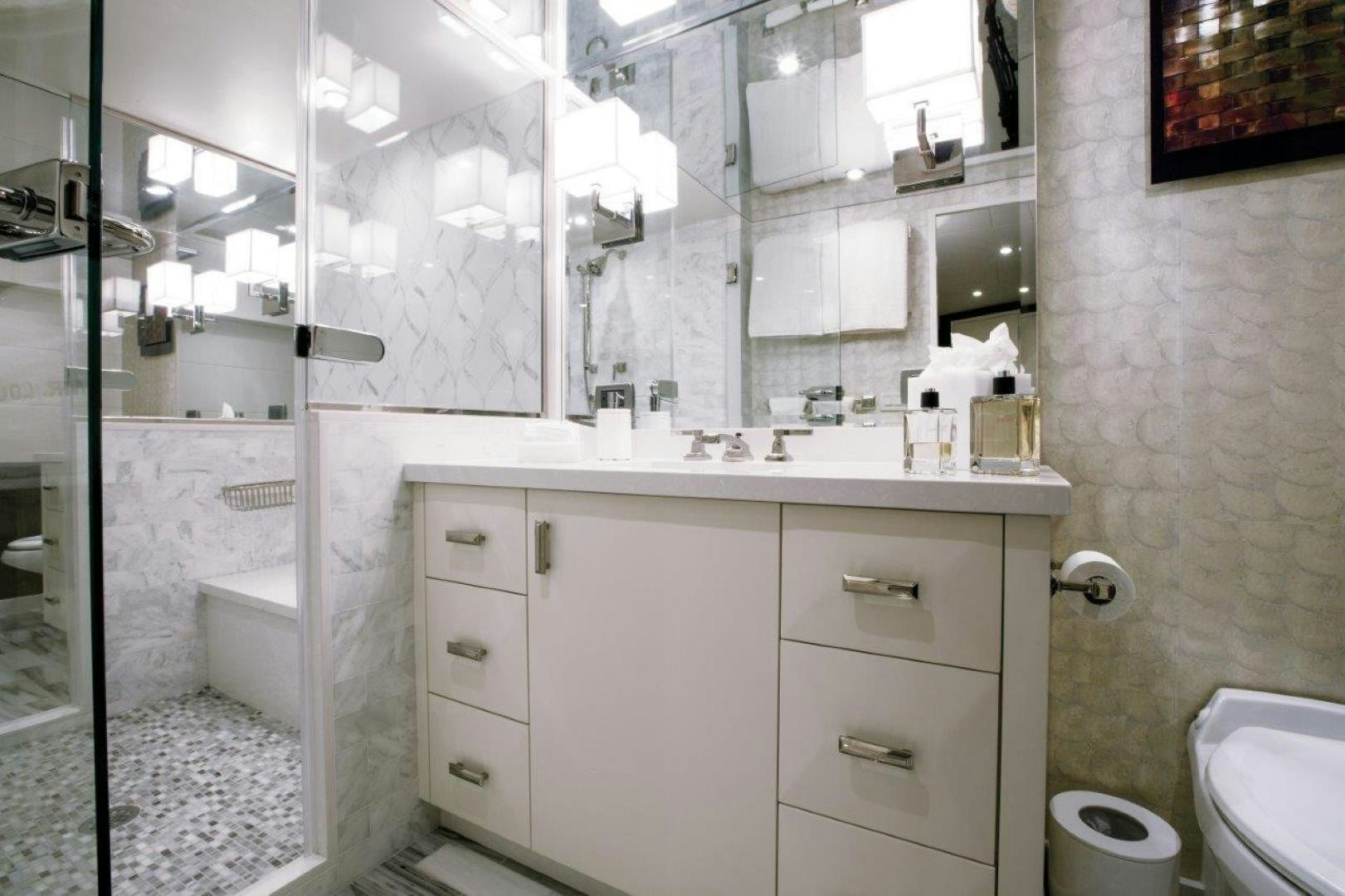 a bathroom with a glass shower aboard 105 RAISED PILOTHOUSE Yacht for Sale