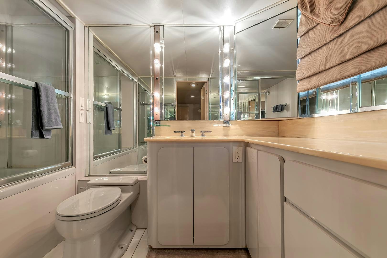 a bathroom with a toilet and a sink aboard LA VIDA Yacht for Sale