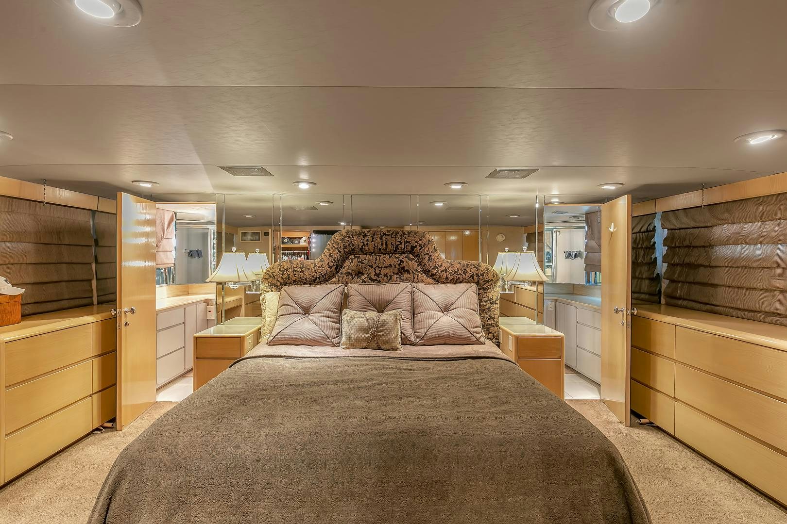 a bedroom with a bed and a dresser aboard LA VIDA Yacht for Sale