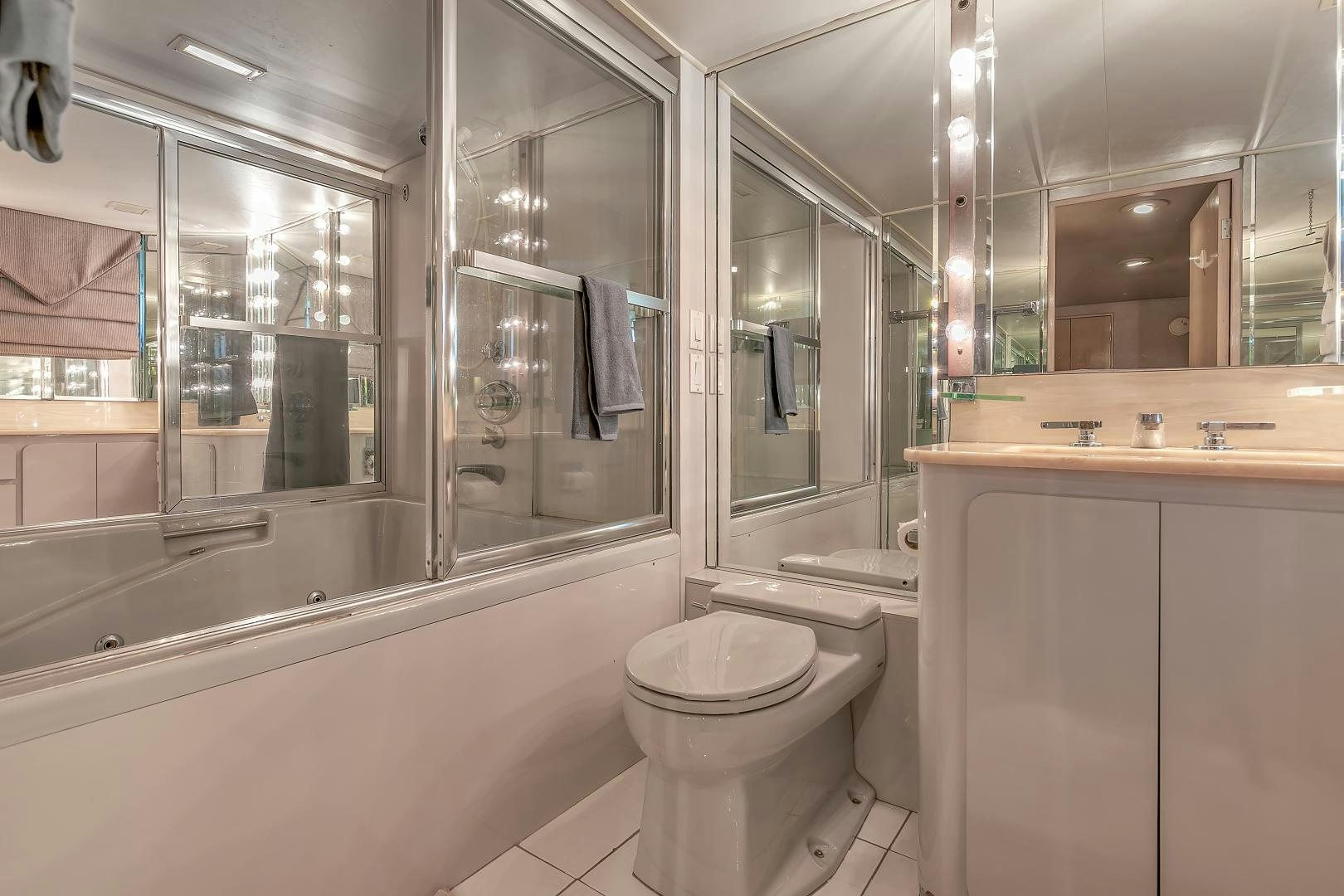 a bathroom with a glass shower aboard LA VIDA Yacht for Sale