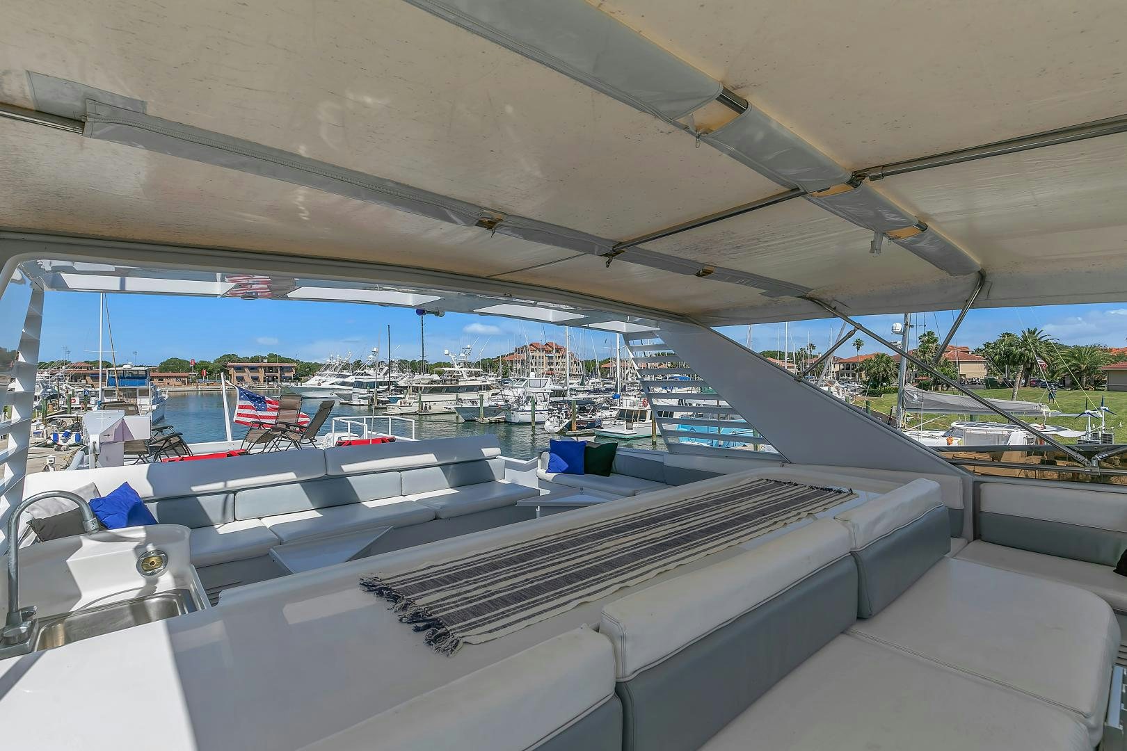 a large room with a large balcony aboard LA VIDA Yacht for Sale