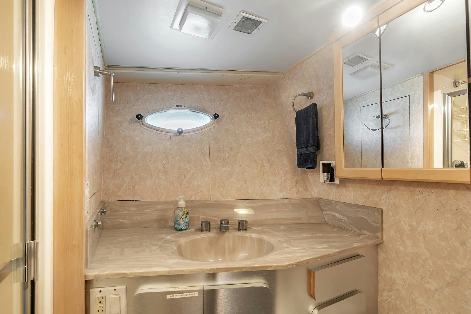 a bathroom with a sink and a mirror aboard LA VIDA Yacht for Sale