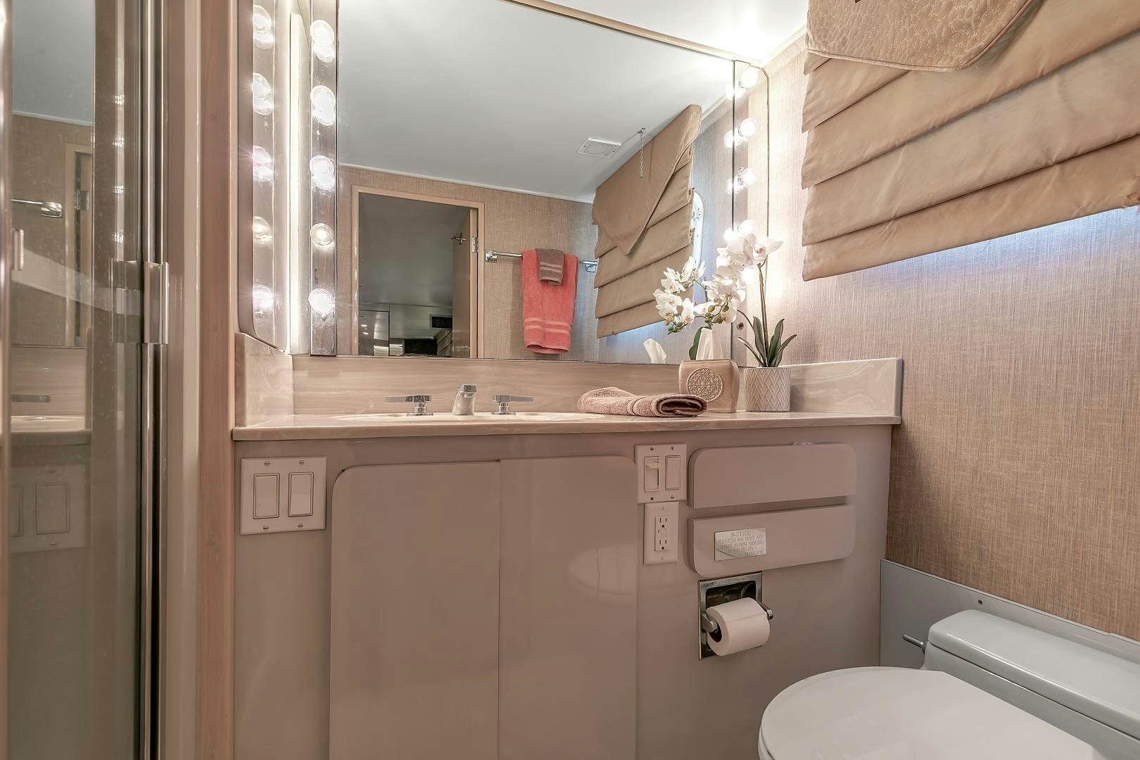 a bathroom with a mirror and a sink aboard LA VIDA Yacht for Sale