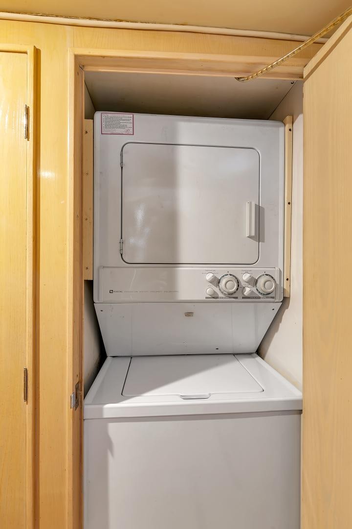 a microwave oven in a wooden cabinet aboard LA VIDA Yacht for Sale