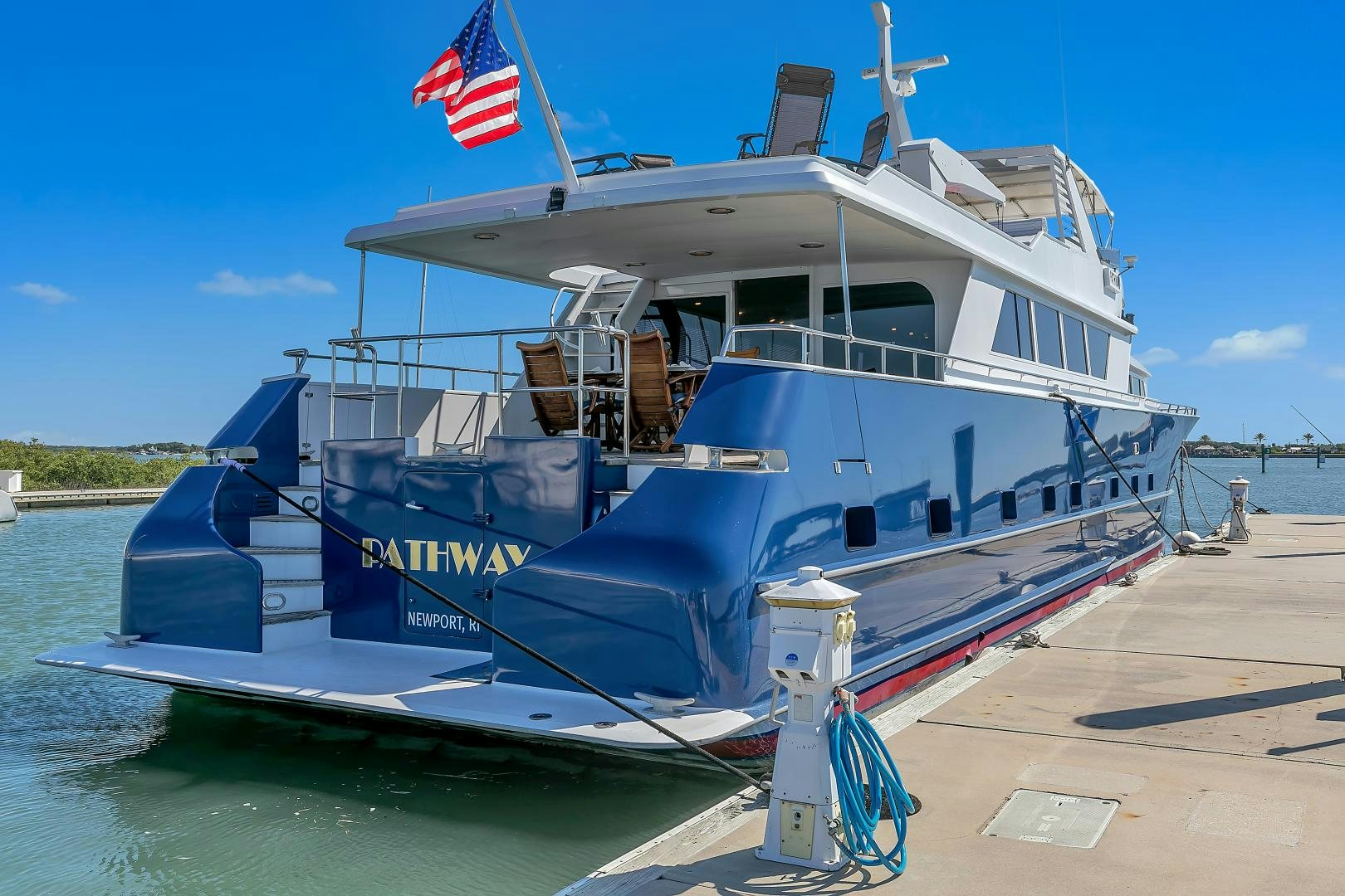 a large boat with a flag on the front aboard LA VIDA Yacht for Sale