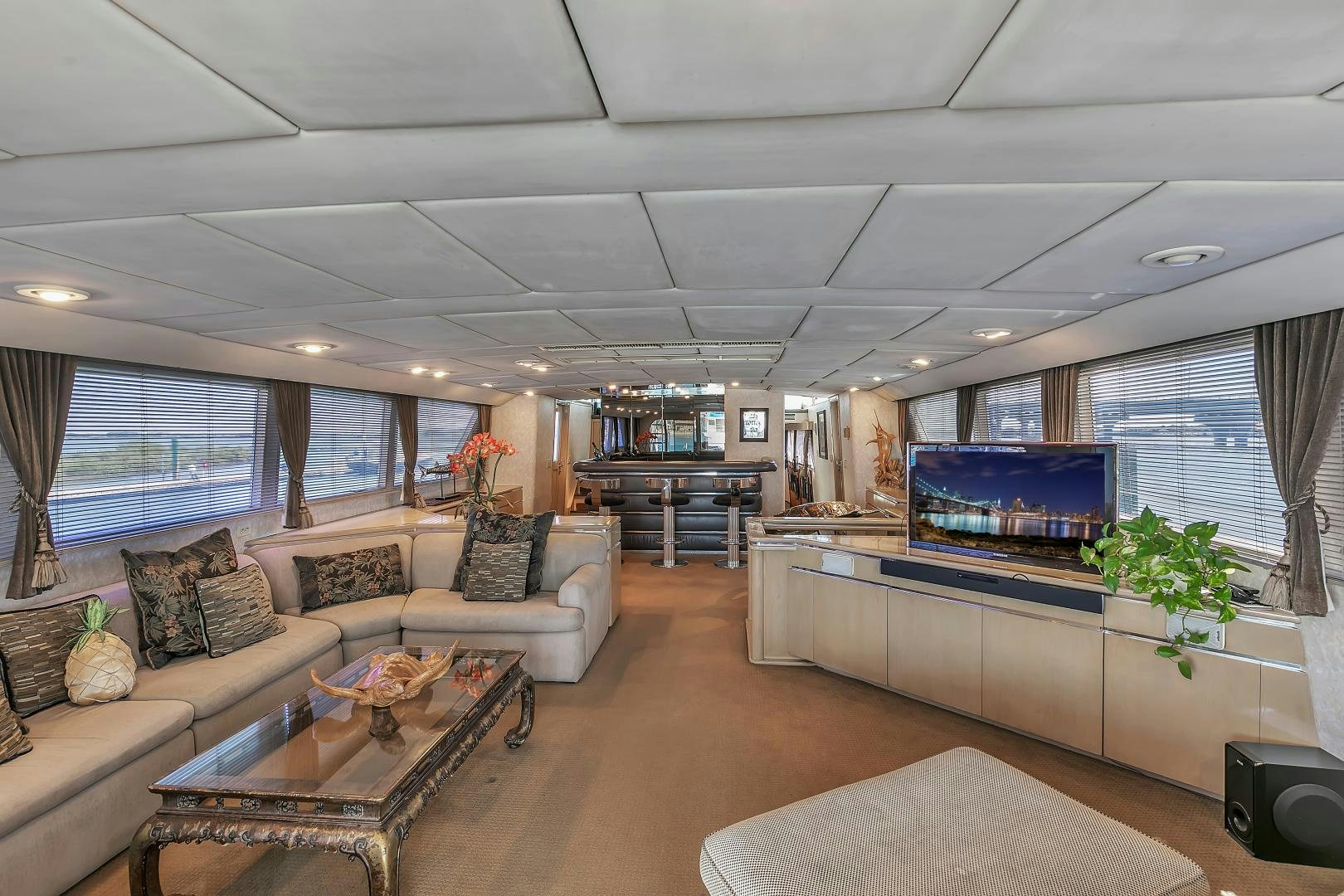 a living room with a large screen aboard LA VIDA Yacht for Sale