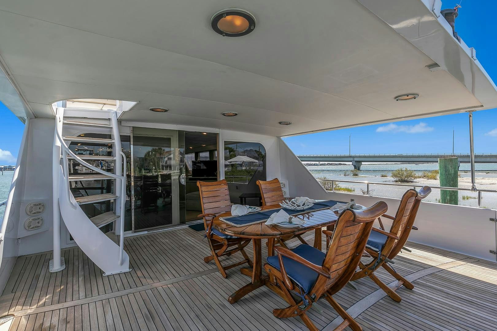 a deck with a table and chairs aboard LA VIDA Yacht for Sale