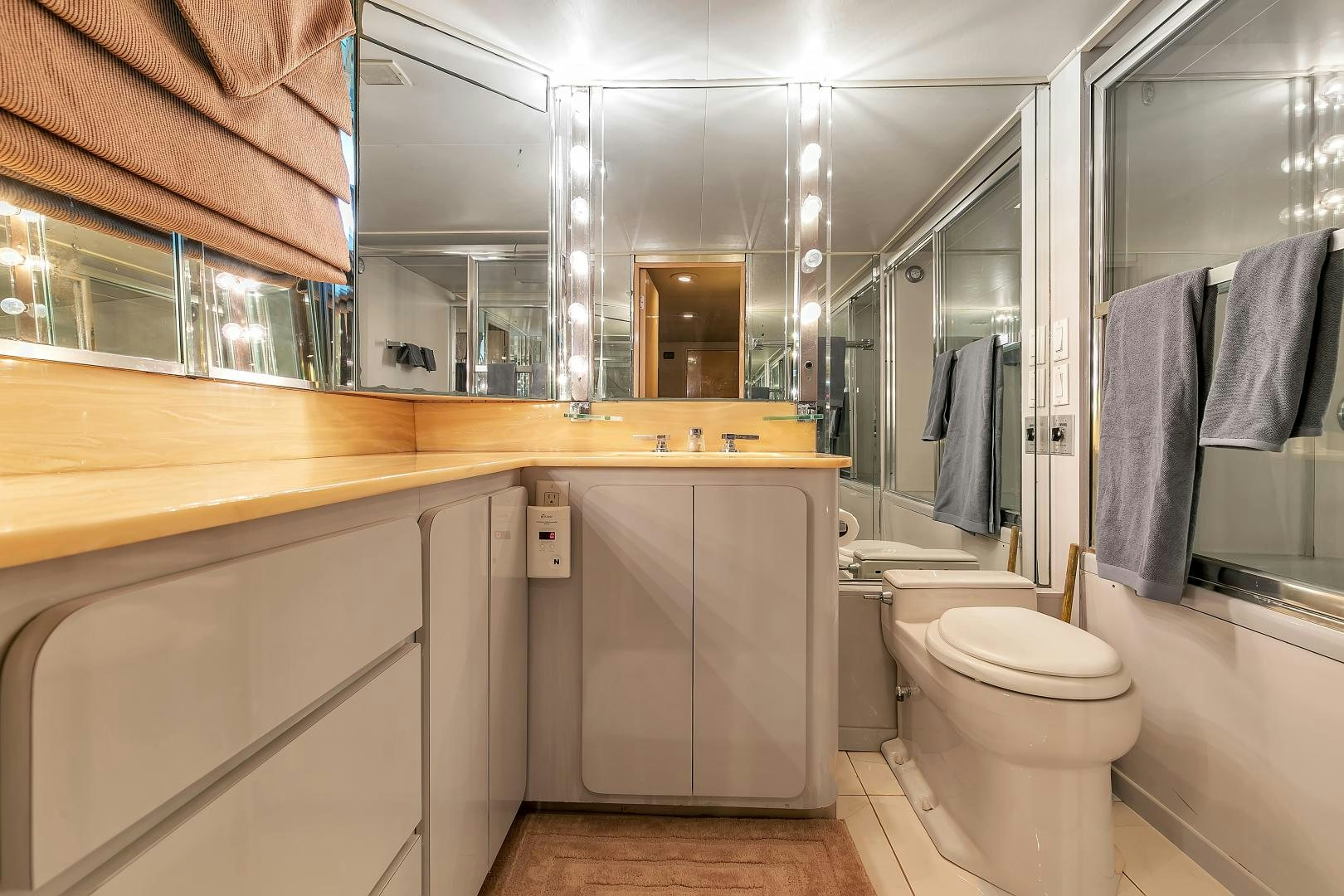 a bathroom with a toilet and a sink aboard LA VIDA Yacht for Sale