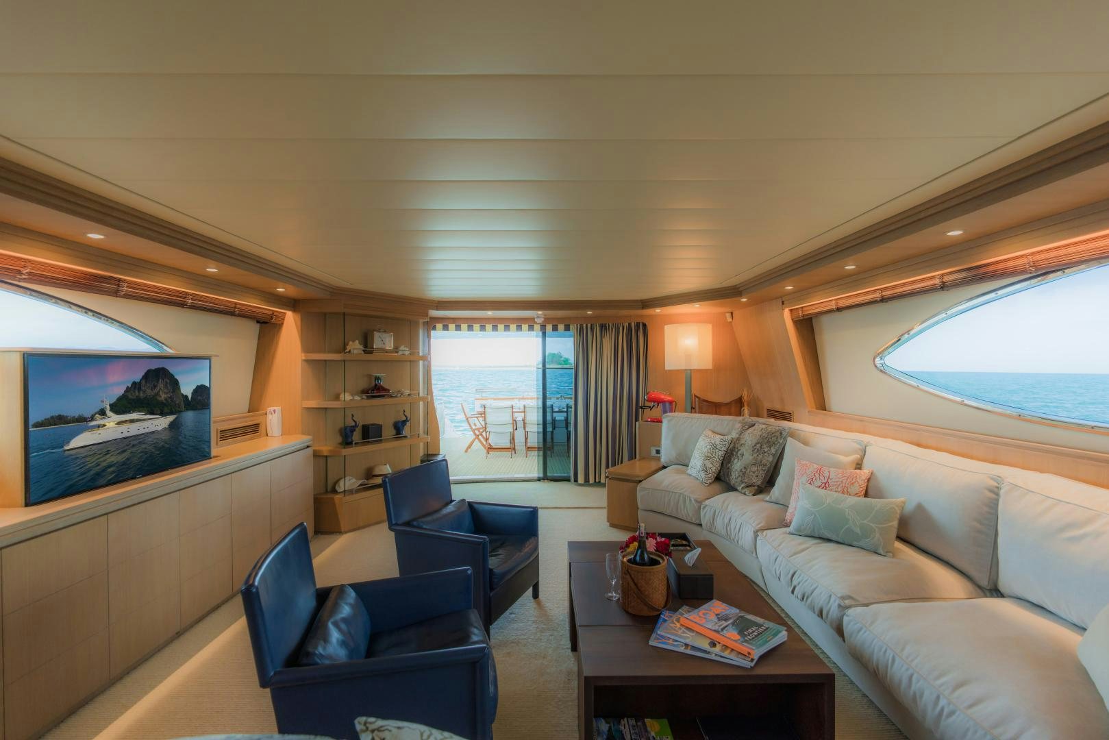 a living room with a large screen aboard AVELINE Yacht for Sale