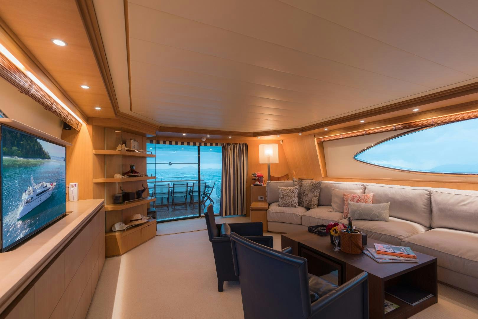 a living room with a large screen aboard AVELINE Yacht for Sale