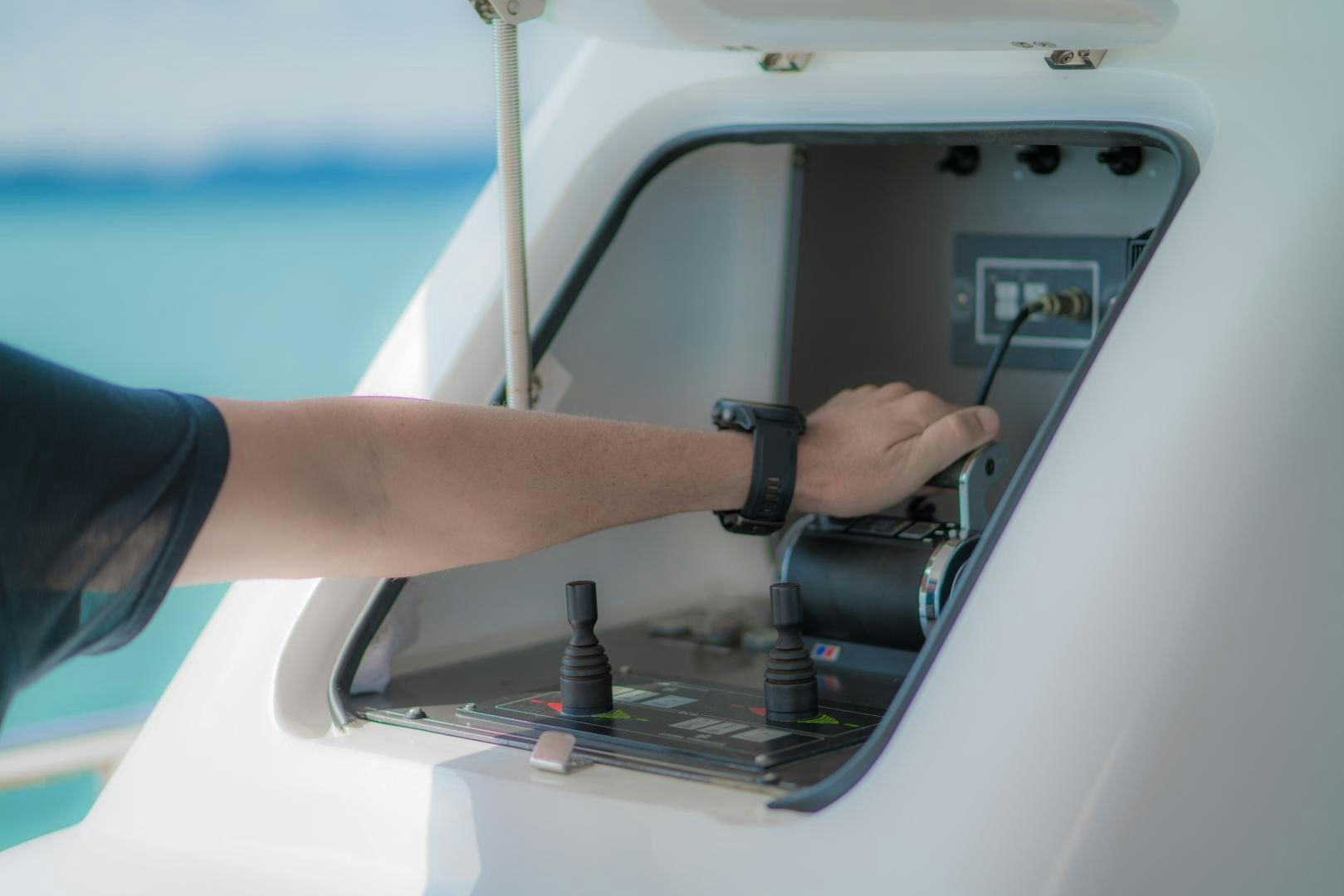 a person holding a device aboard AVELINE Yacht for Sale