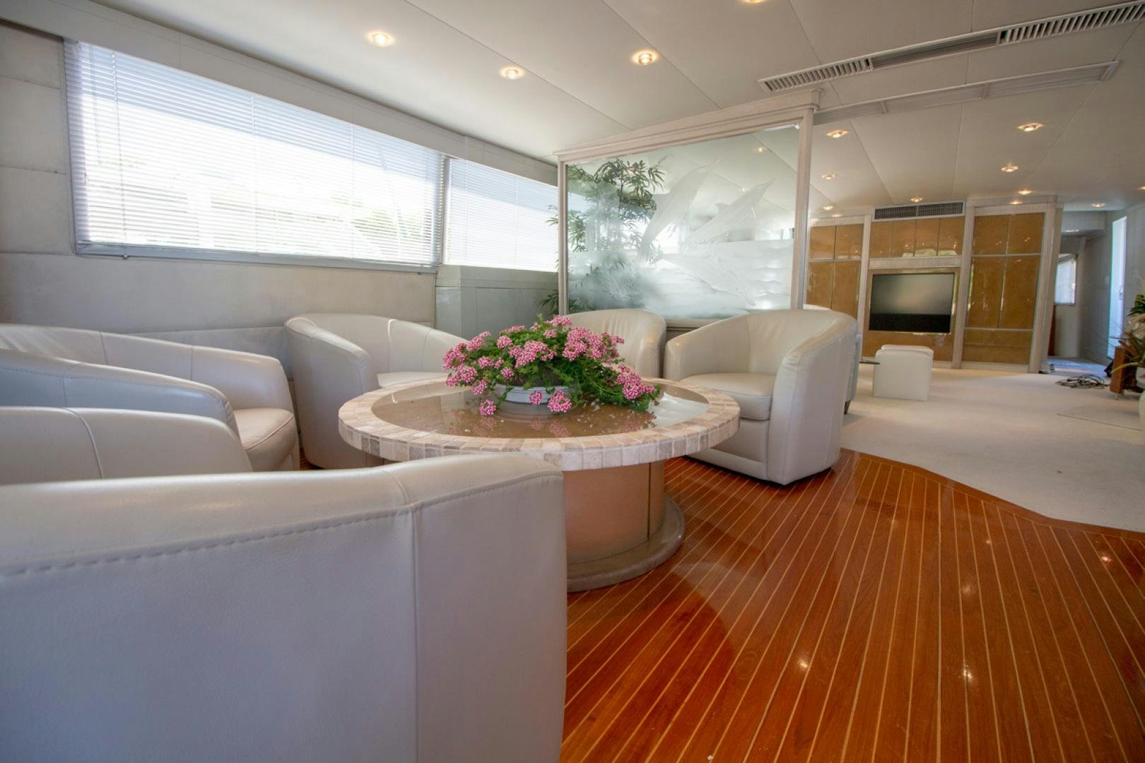 a living room with a table and couches aboard LIQUIDITY Yacht for Sale
