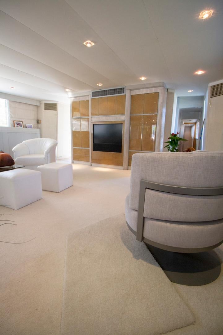 a living room with a fireplace aboard LIQUIDITY Yacht for Sale