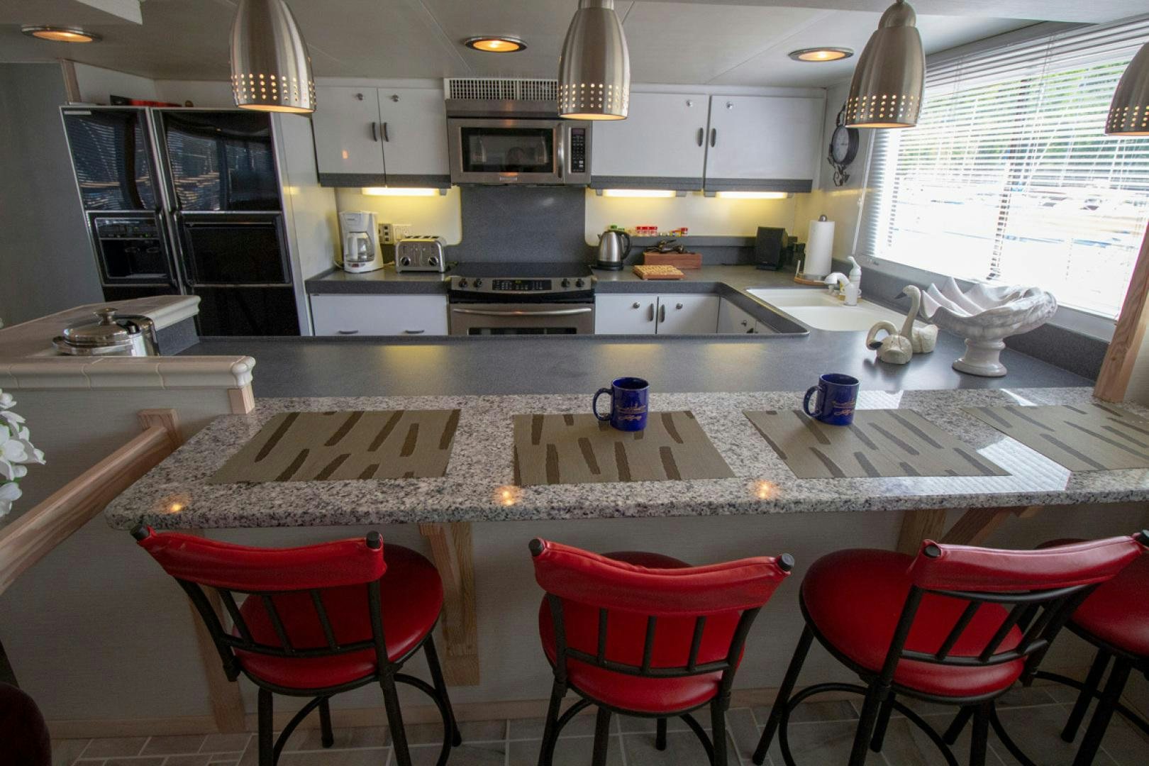 a kitchen with a table and chairs aboard LIQUIDITY Yacht for Sale