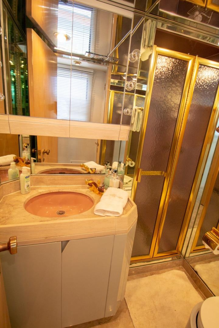 a bathroom with a sink and a mirror aboard LIQUIDITY Yacht for Sale