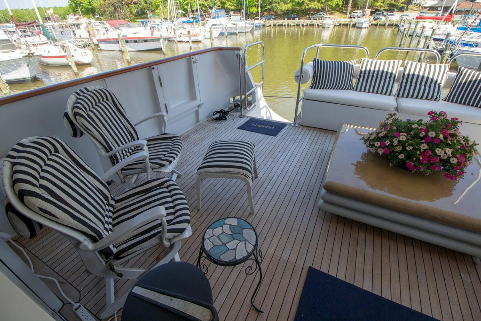 a boat with a flower pot on the deck aboard LIQUIDITY Yacht for Sale
