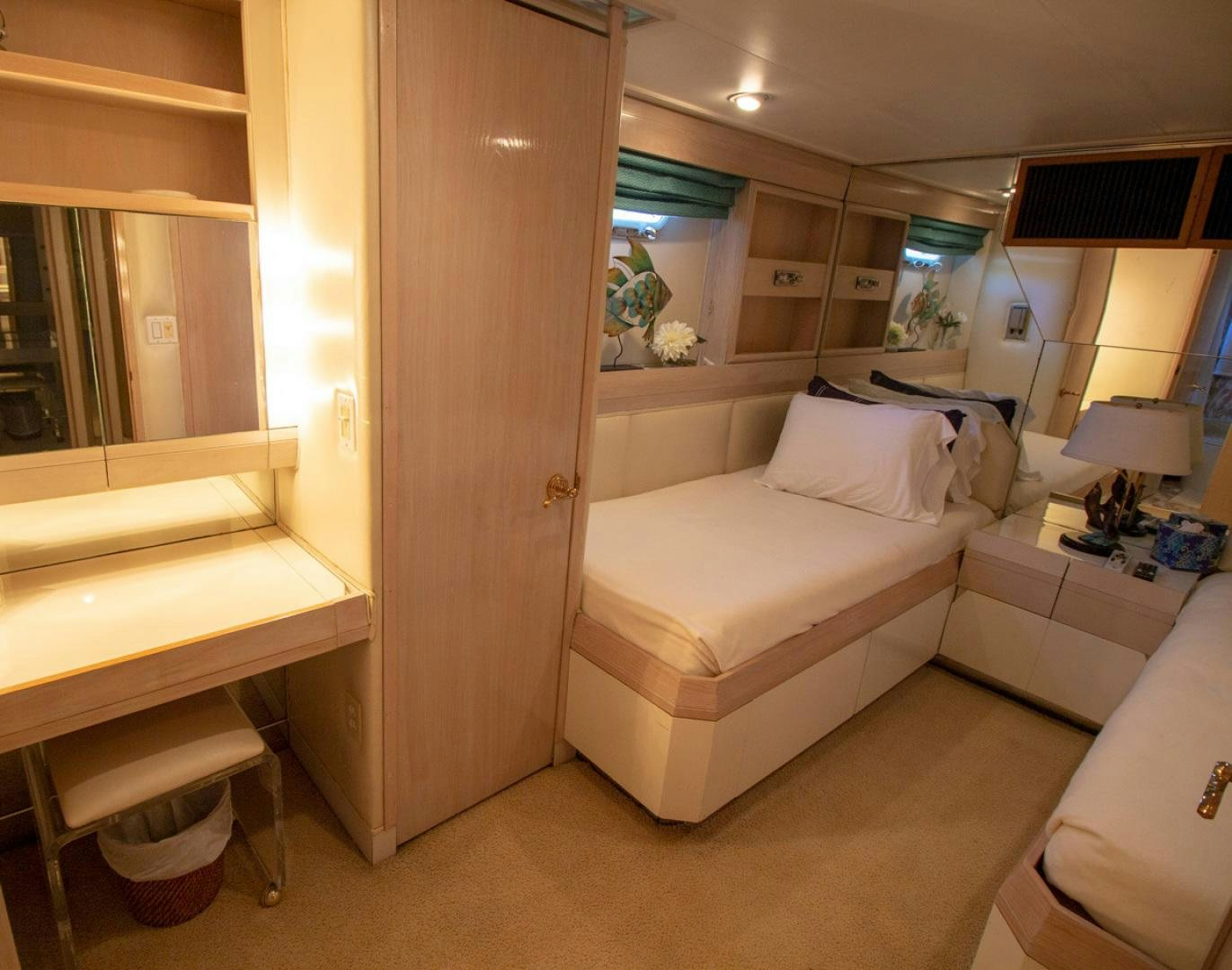 a room with a bed and a mirror aboard LIQUIDITY Yacht for Sale