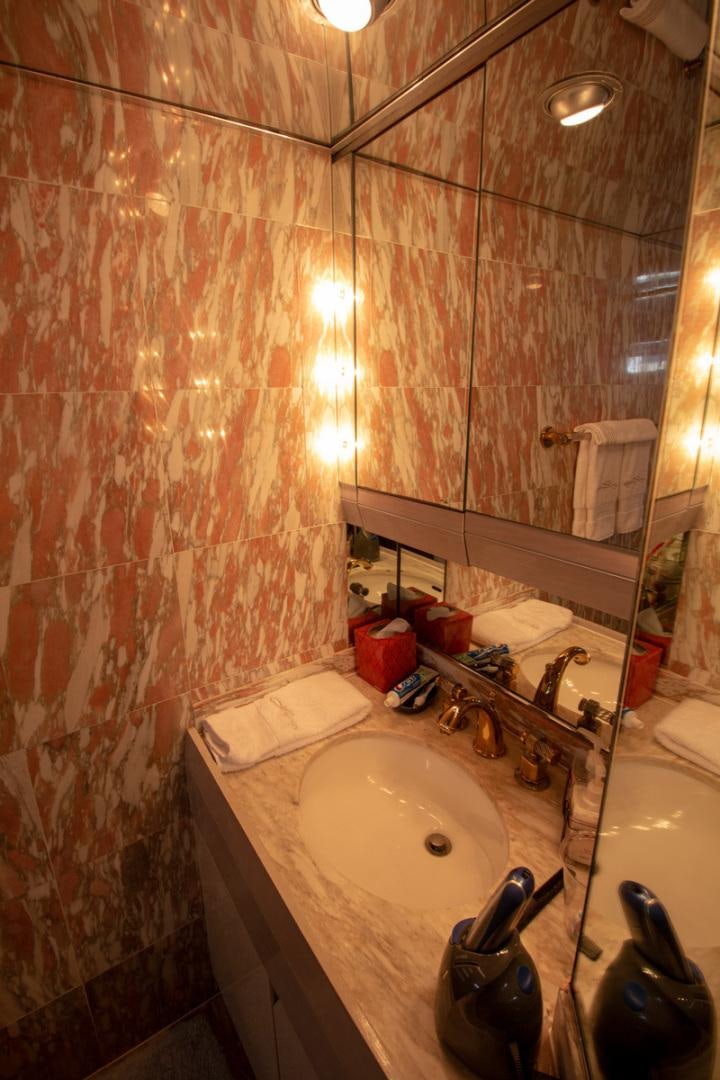 a bathroom with a sink and a mirror aboard LIQUIDITY Yacht for Sale