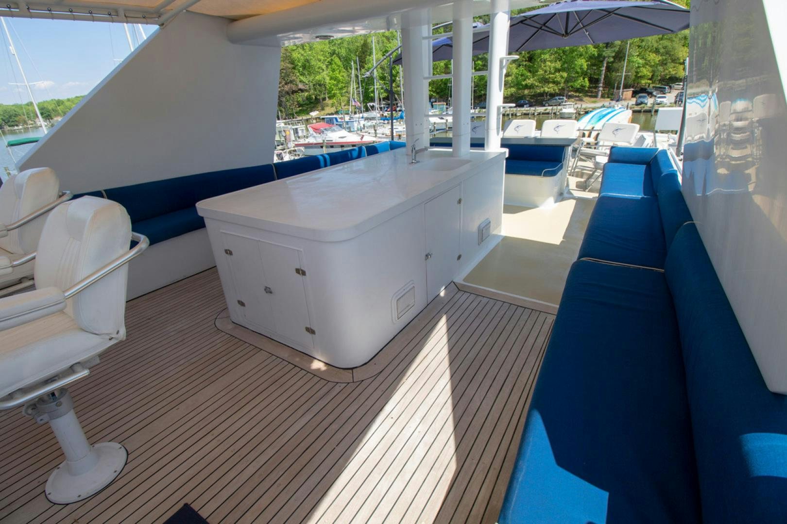 a deck with a pool and chairs aboard LIQUIDITY Yacht for Sale
