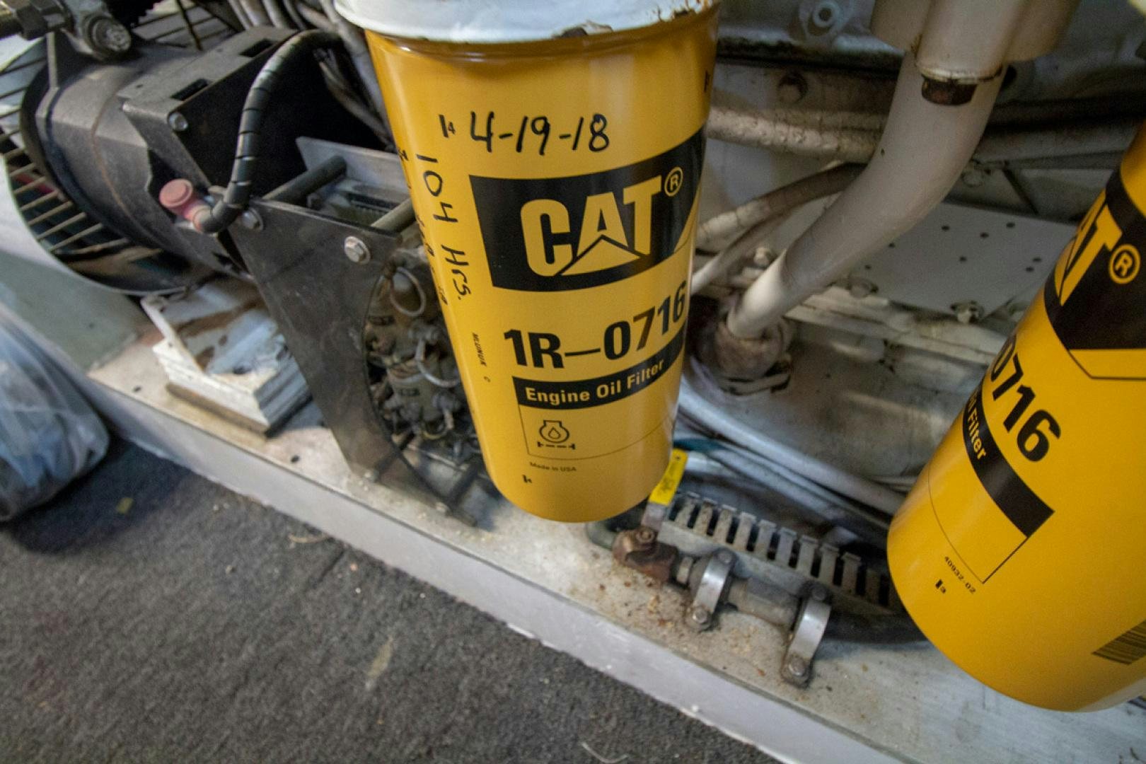 a yellow and black can next to a yellow construction vehicle aboard LIQUIDITY Yacht for Sale