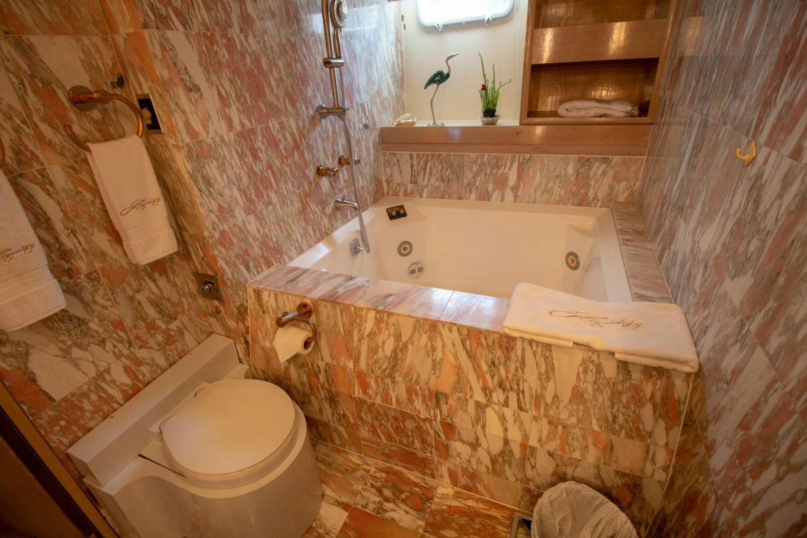 a bathroom with a tub toilet and sink aboard LIQUIDITY Yacht for Sale