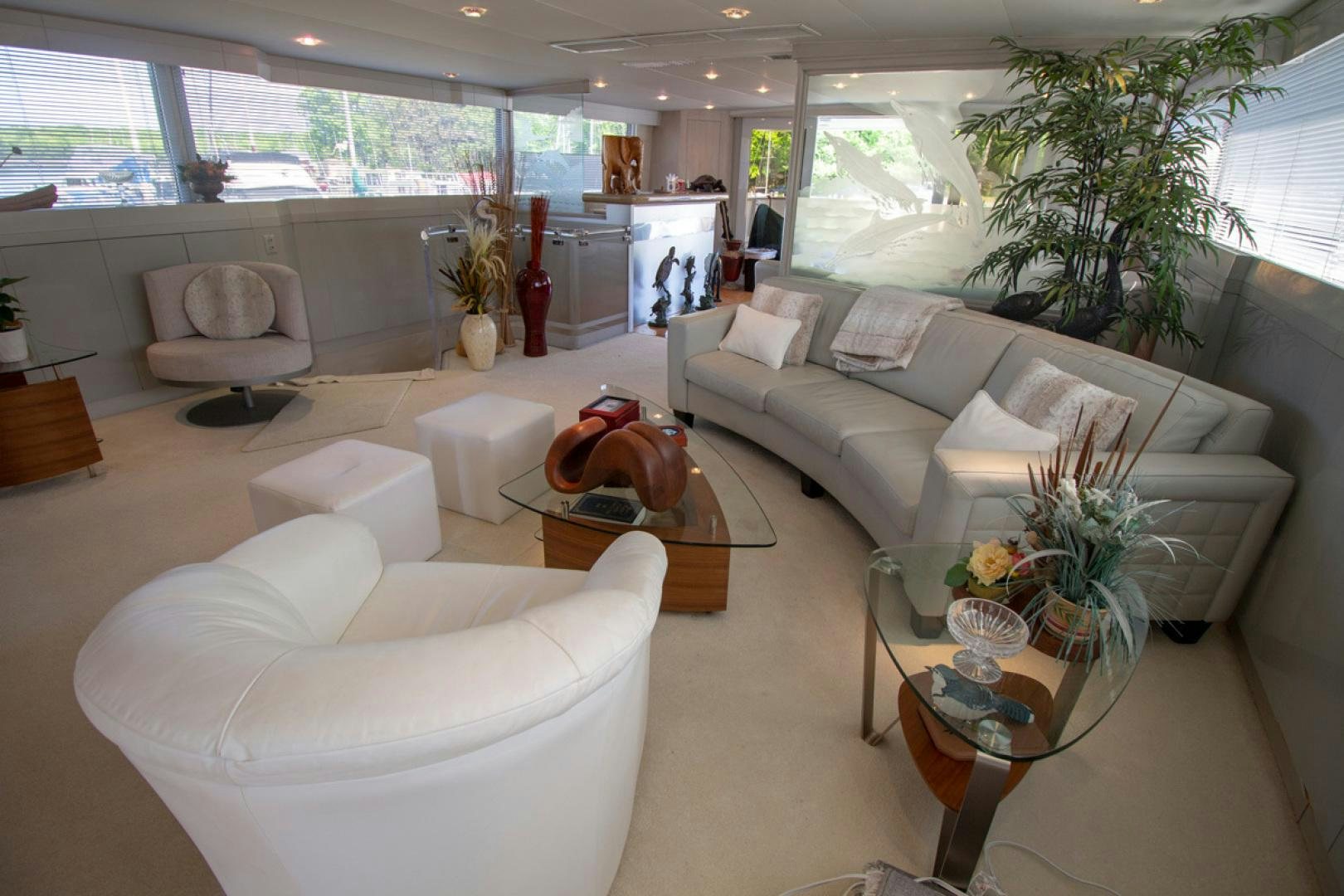 a living room with white furniture aboard LIQUIDITY Yacht for Sale