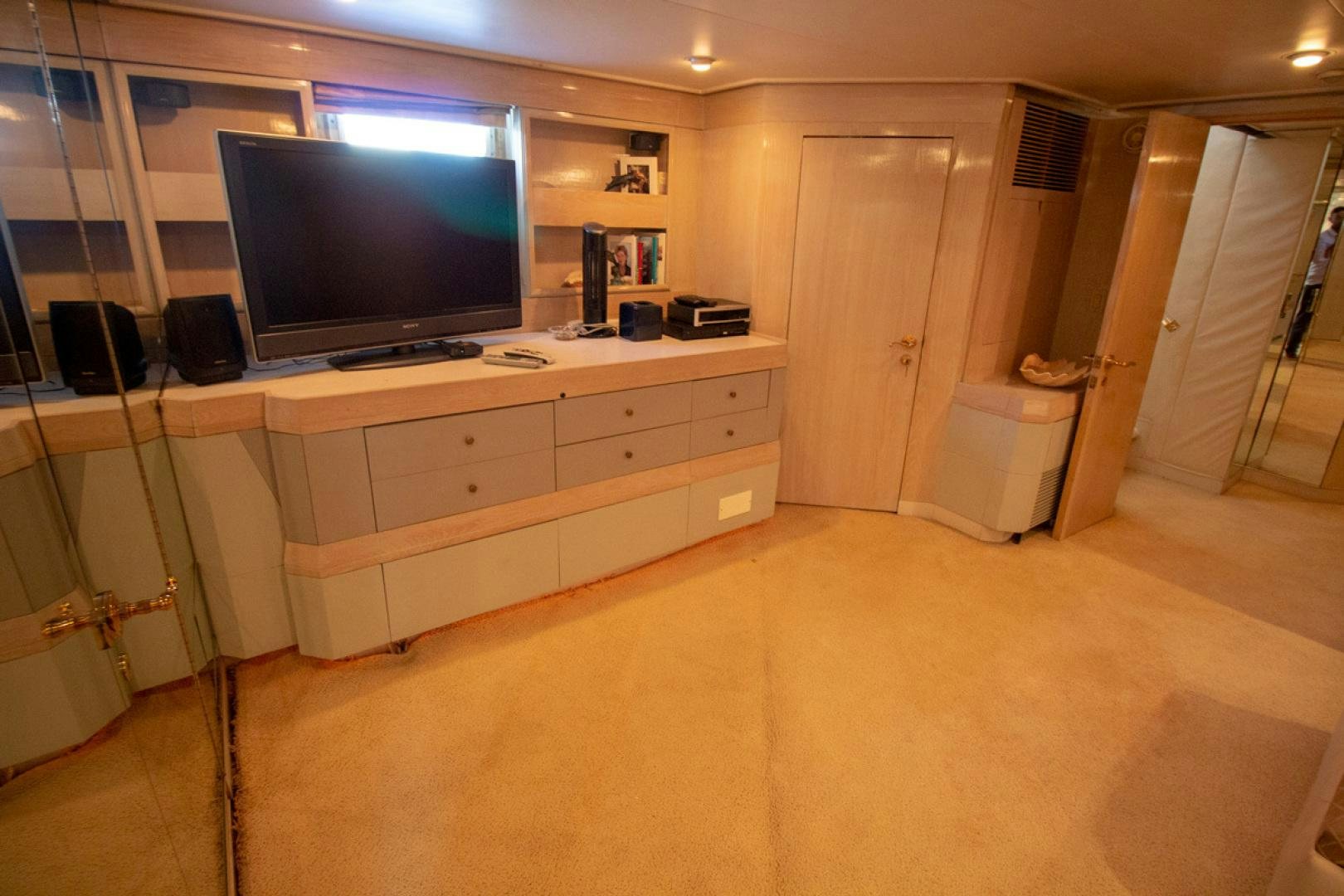 a room with a tv and a dresser aboard LIQUIDITY Yacht for Sale