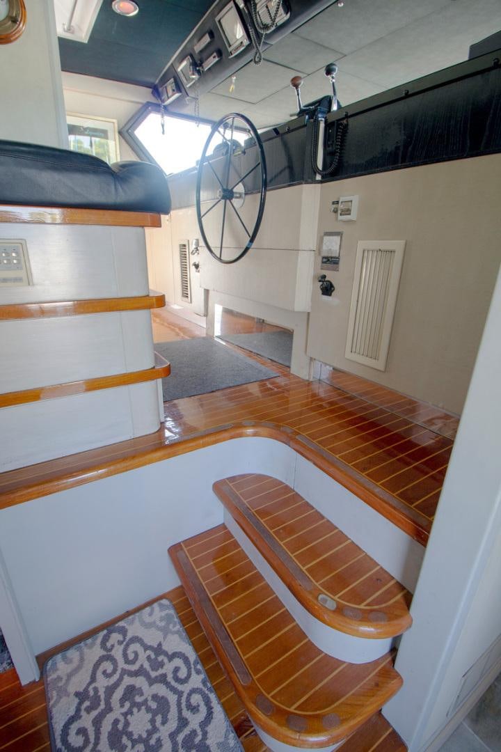 a room with a bench and a bicycle aboard LIQUIDITY Yacht for Sale