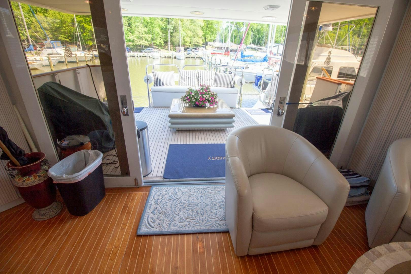 a living room with a sliding glass door aboard LIQUIDITY Yacht for Sale